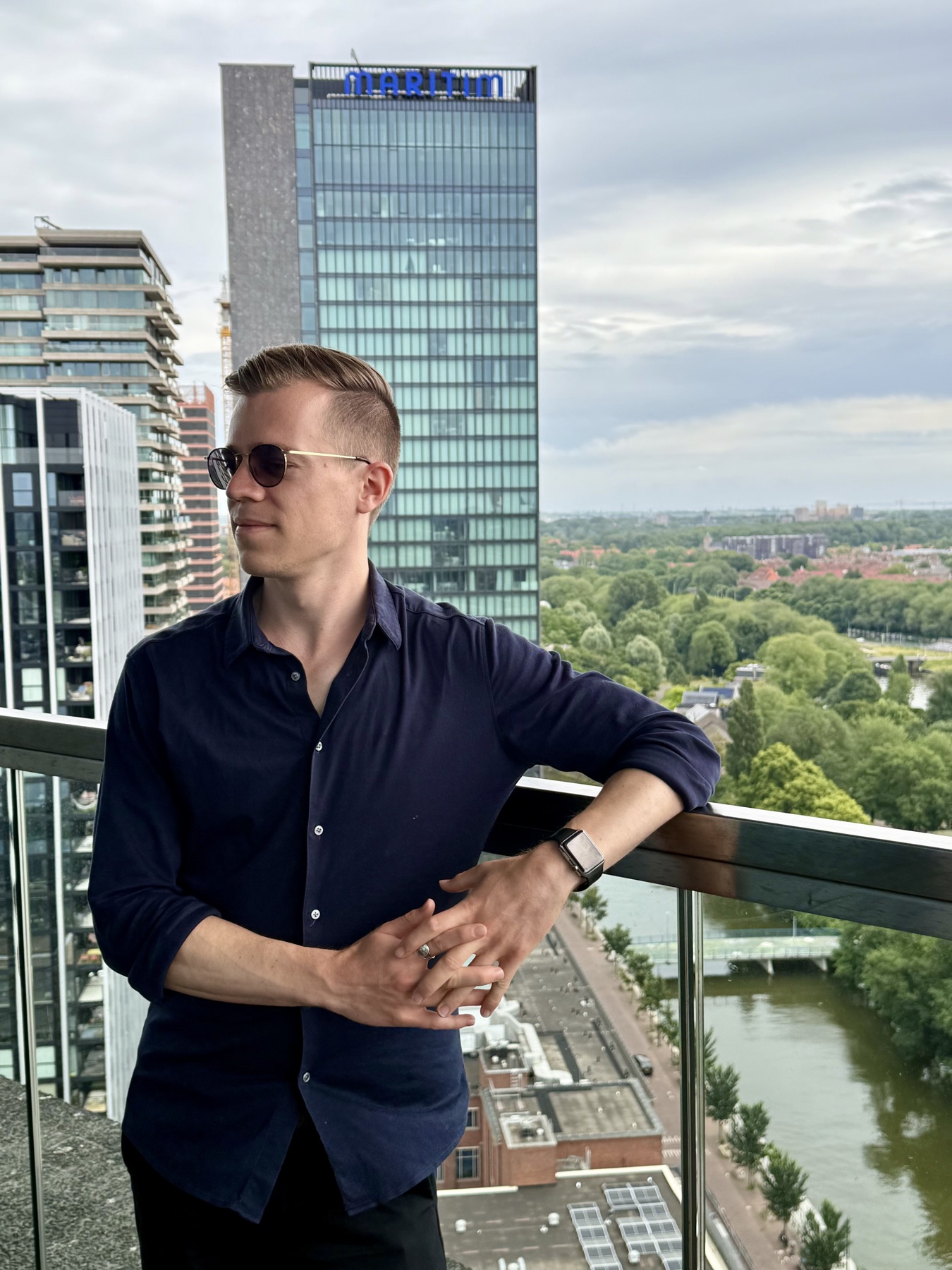 Youri Hermes on a balcony overlooking the city